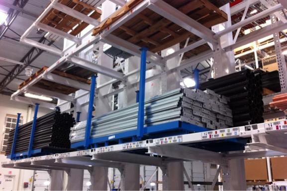 Industrial storage racks holding metal materials and pallets in a warehouse.
